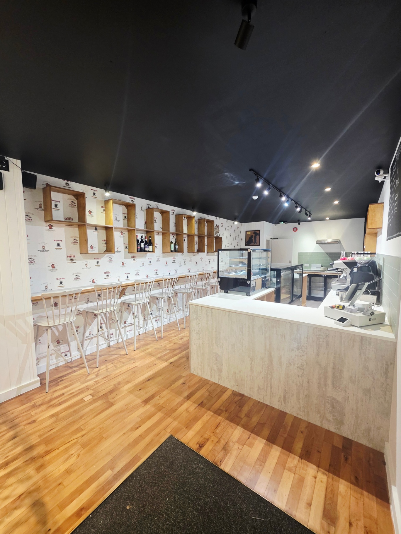 Aromagsy interior looking towards the seating with birch shelving and dark ceiling