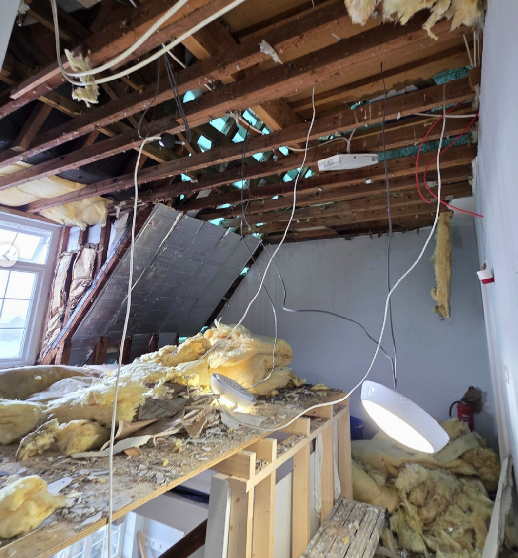 Storm damage and exposed roof timbers inside Lihou Island House