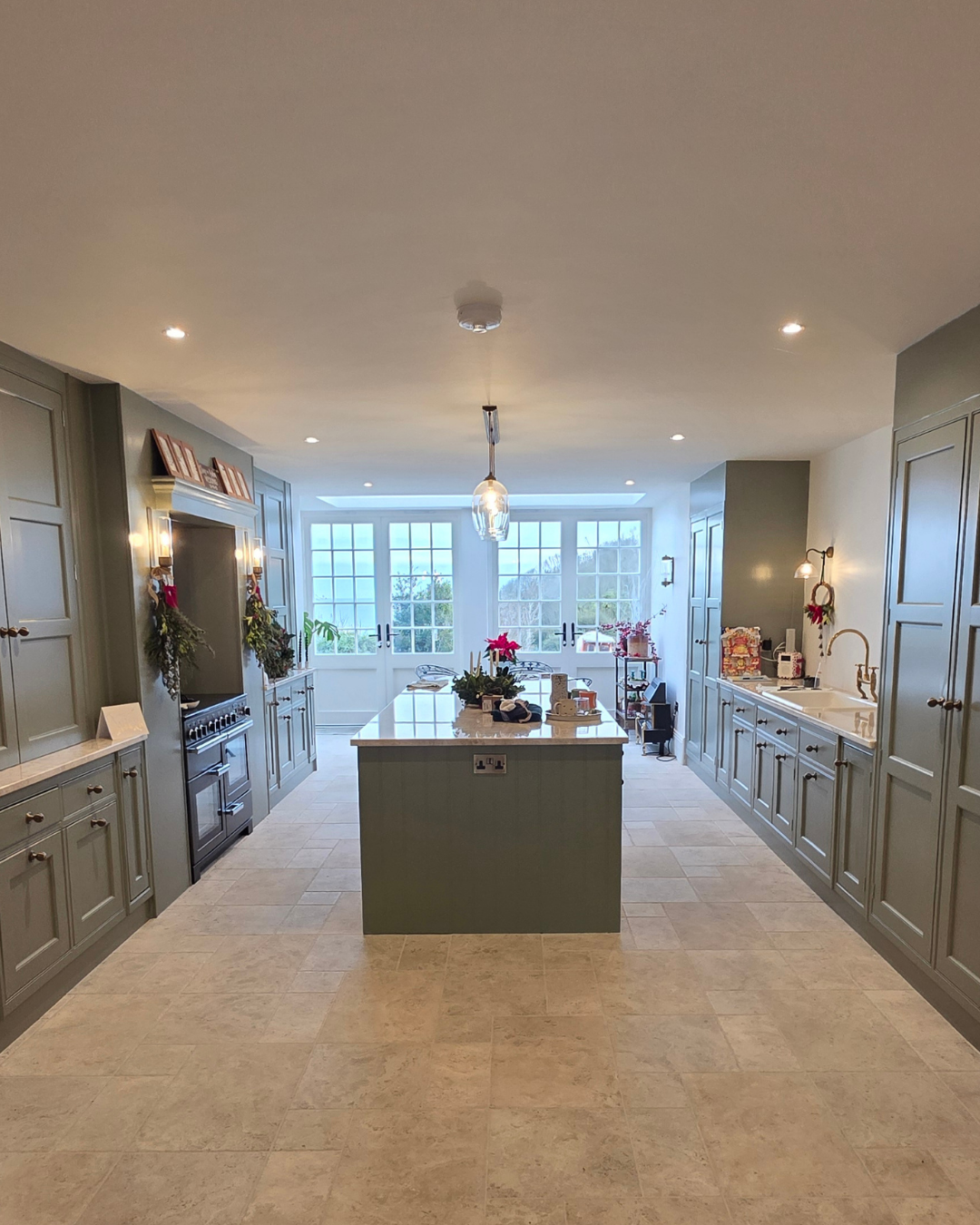 Wide view of the finished kitchen looking through to garden windows