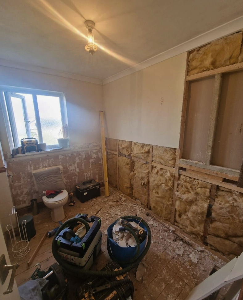 Bathroom stripped back to studs and insulation ready for preparation