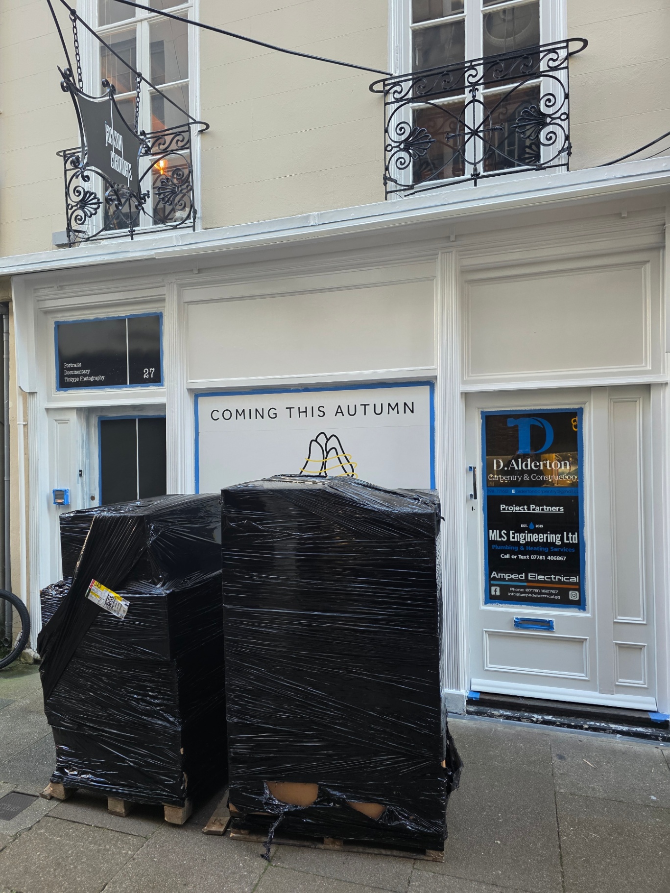 Aromagsy shopfront on a St Peter Port lane with 'Coming this Autumn' hoarding and D.Alderton signage