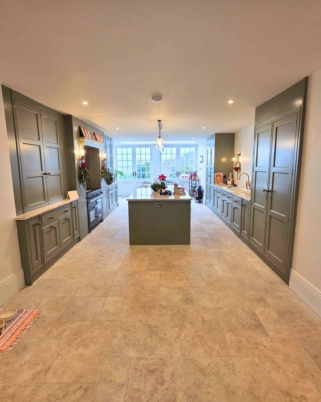 Finished sage green kitchen with central island